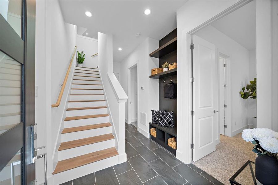 Downstairs includes two bedrooms with a full bathroom and a bench/mudroom area for coats and storage!