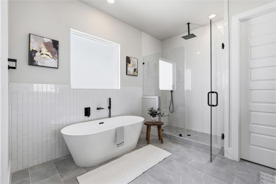 Positioned alongside the soaking tub, the walk-in shower offers both functionality and a seamless, open design. Positioned alongside the soaking tub, the walk-in shower offers both functionality and a seamless, open design.