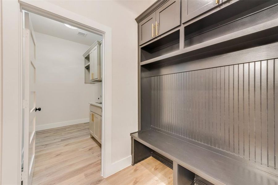 Mudroom with light wood-style floors and baseboards Mudroom with light wood-style floors and baseboards