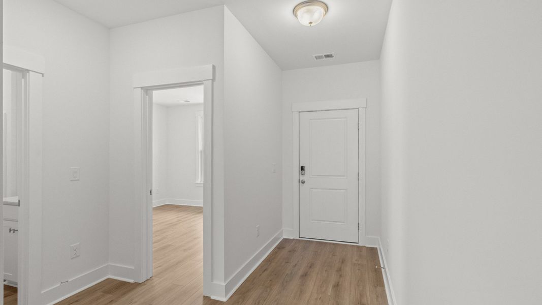Bright hallway connects the main living areas to secondary bedrooms with ease. Bright hallway connects the main living areas to secondary bedrooms with ease.