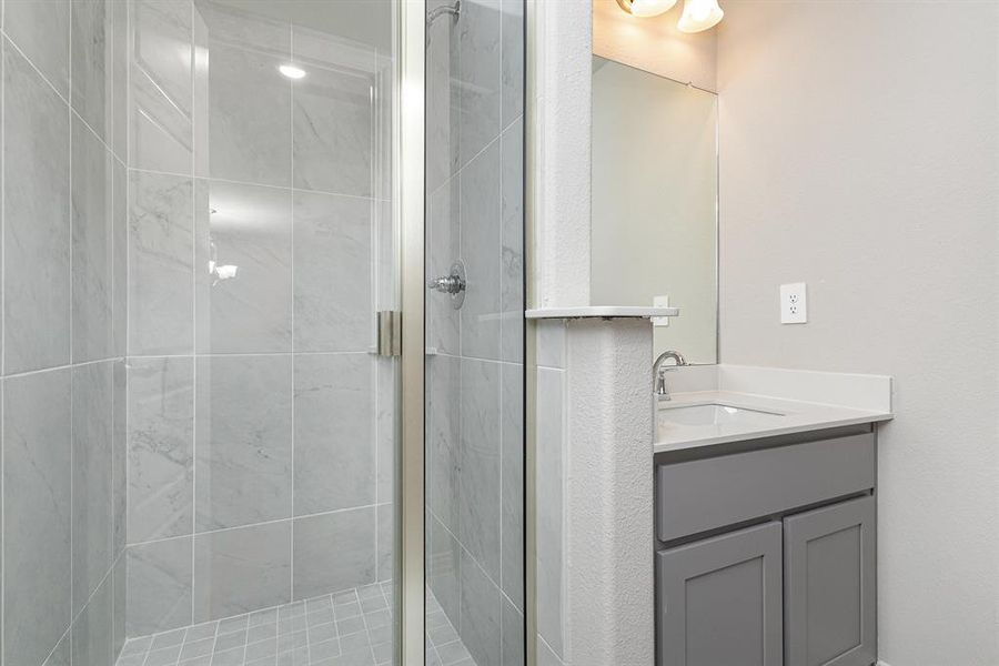 Bathroom featuring vanity and walk in shower