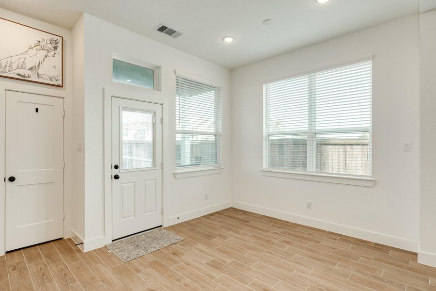 This image displays the dining area, back door, and pantry.