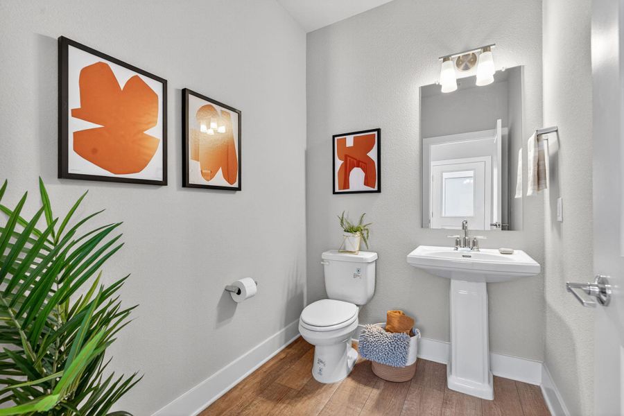 Bathroom featuring wood finished floors and toilet