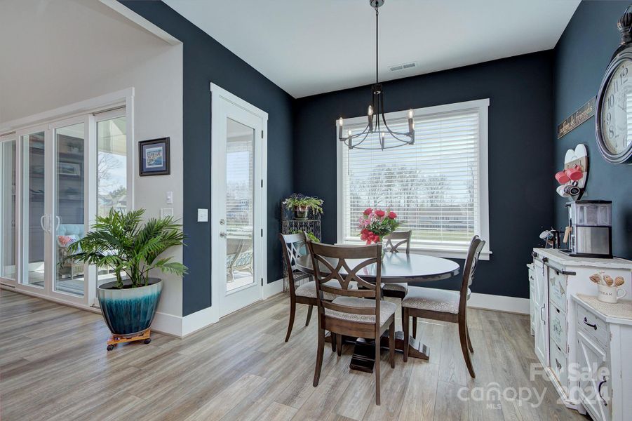 Eat in dining area with exit door to the screen porch and large picture window overlooking back yard