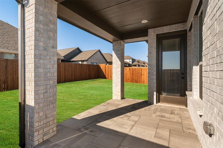 The Covered Backyard Patio is the Perfect Spot to Grill and Entertain