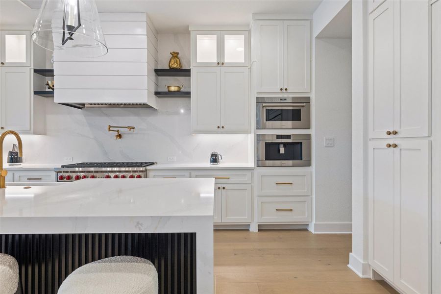 Impeccably designed, the kitchen features stunning tumbled brass accents that beautifully compliment the high-end appliances and exquisite finishes