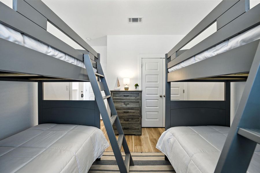 Bedroom featuring vinyl plank flooring and high ceiling Bedroom featuring vinyl plank flooring and high ceiling