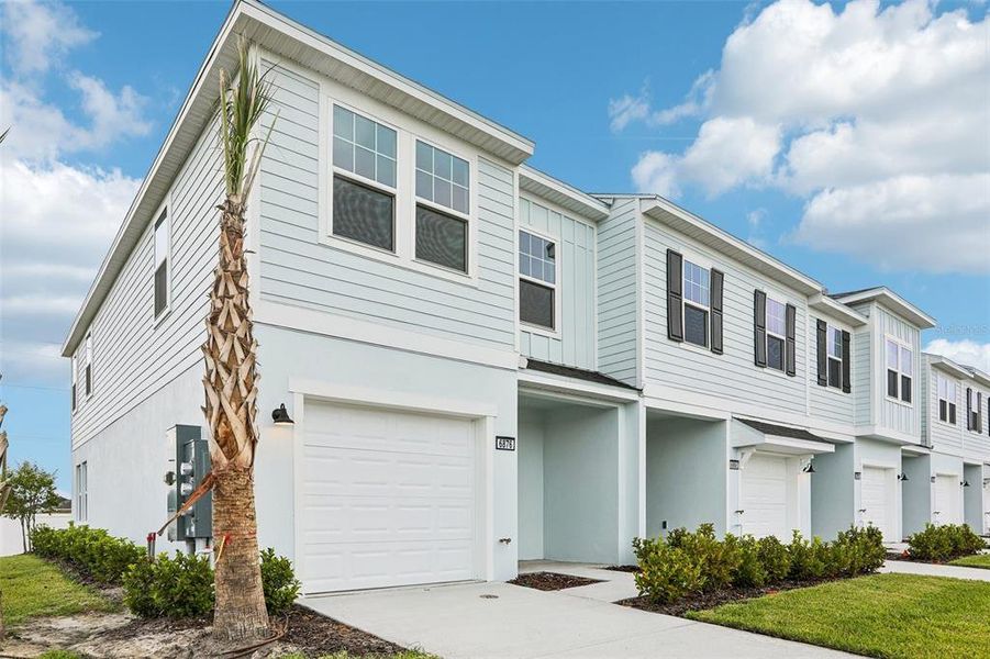 Front exterior of a new home in Twin Oaks, Zephyrhills, FL, highlighting curb appeal (Image 2). Front exterior of a new home in Twin Oaks, Zephyrhills, FL, highlighting curb appeal (Image 2).