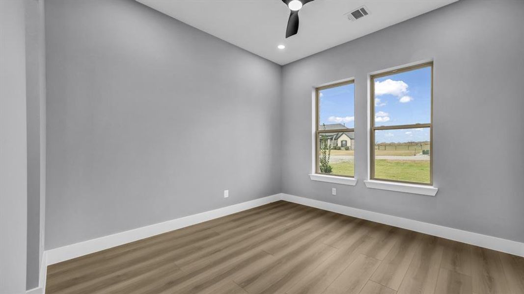 Unfurnished room featuring wood finished floors, a ceiling fan, and recessed lighting