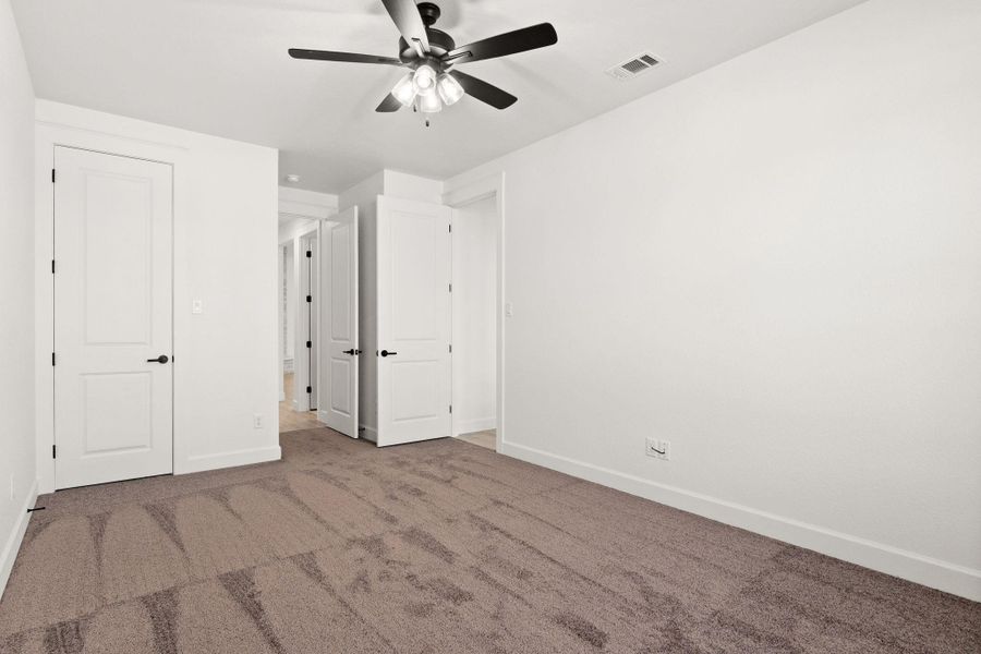 Unfurnished bedroom featuring carpet floors and a ceiling fan