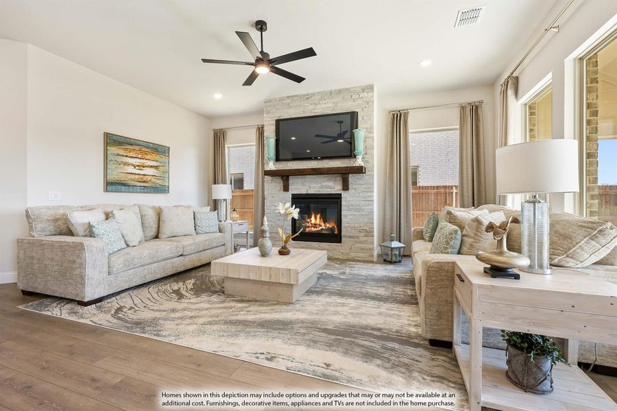 Living room with stone fireplace, ceiling fan, hardwood floors, and two neutral sofas Living room with stone fireplace, ceiling fan, hardwood floors, and two neutral sofas