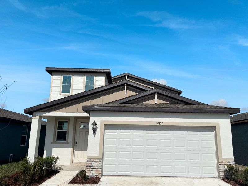 Front exterior of a new home in Benton Hills - Premier Series, Brooksville, FL, highlighting curb appeal (Image 1). Front exterior of a new home in Benton Hills - Premier Series, Brooksville, FL, highlighting curb appeal (Image 1).