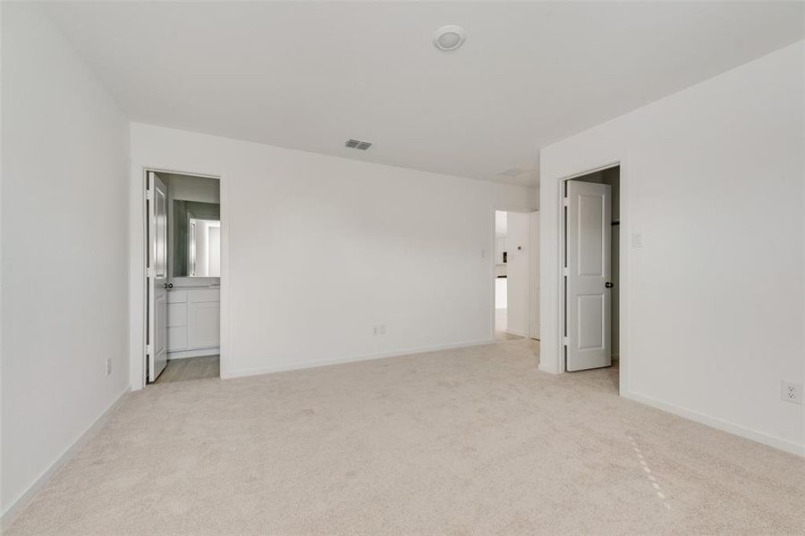 Unfurnished bedroom featuring light colored carpet