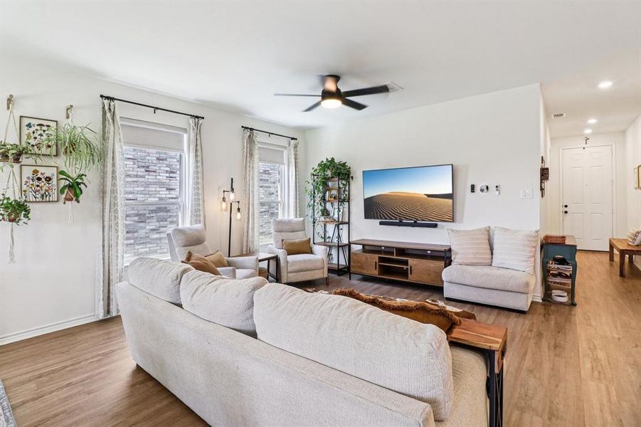 Living room featuring wood finished floors, ceiling fan, and recessed lighting Living room featuring wood finished floors, ceiling fan, and recessed lighting