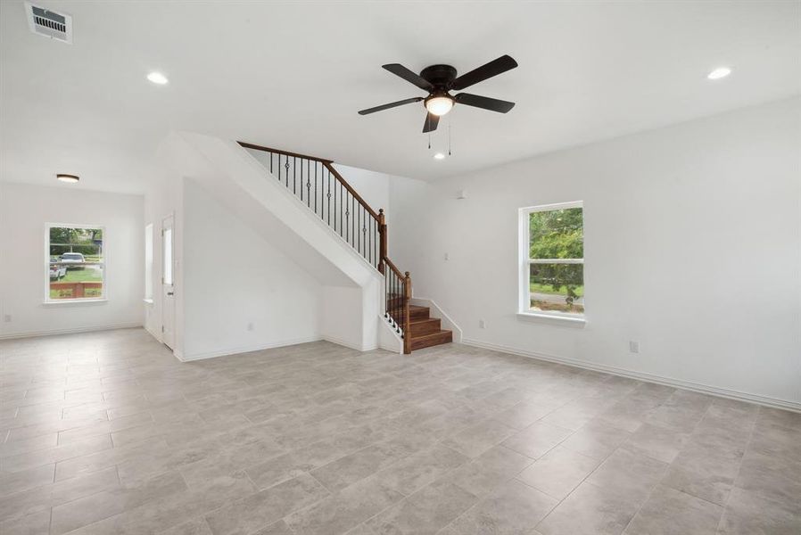 Unfurnished living room with ceiling fan