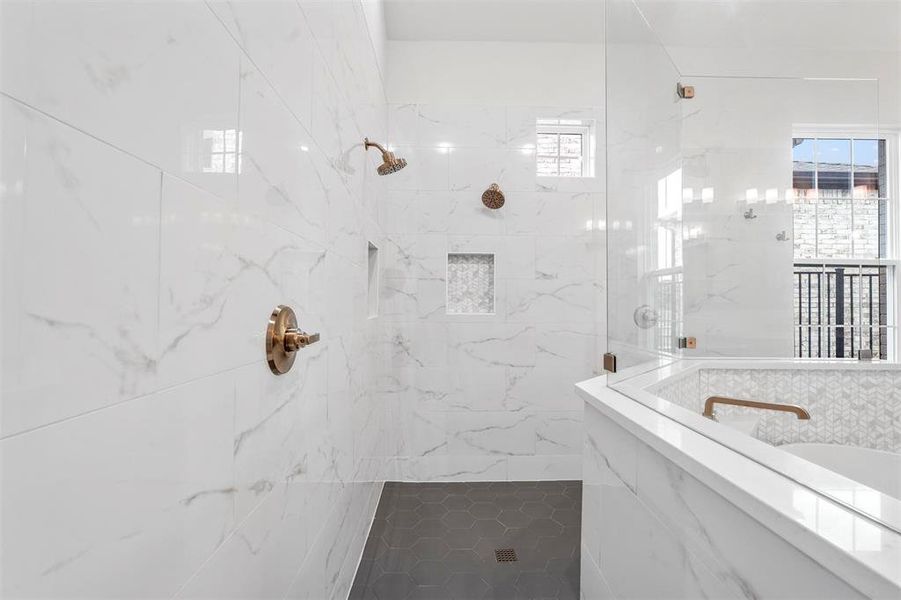 Bathroom featuring a tile shower and tile walls