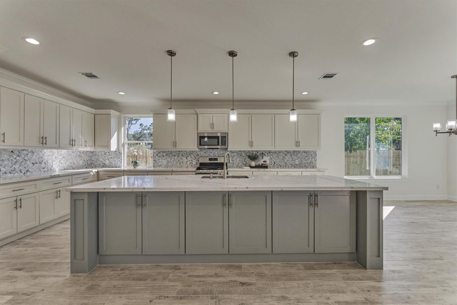 This jaw-dropping chef's kitchen is a dream come true! Showcasing an oversized island with bar seating, pendant lighting, soft closing drawers & cabinets, an XL walk-in pantry, and much more. This jaw-dropping chef's kitchen is a dream come true! Showcasing an oversized island with bar seating, pendant lighting, soft closing drawers & cabinets, an XL walk-in pantry, and much more.