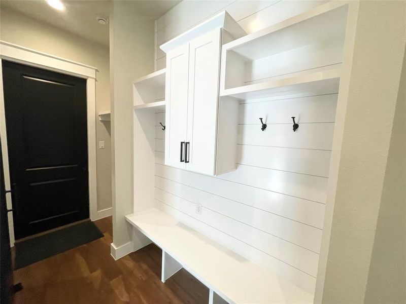 Mudroom off garage with built ins has lots of storage