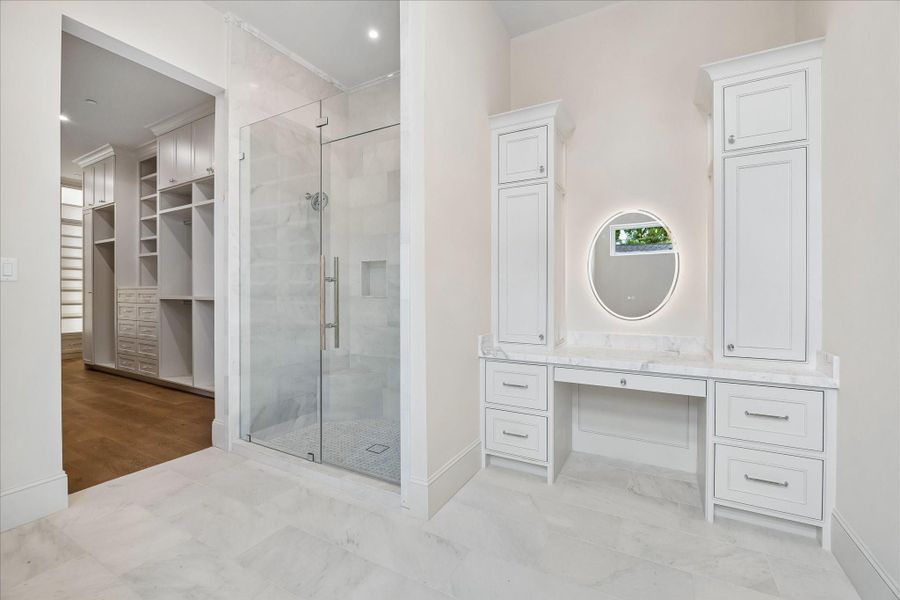 Primary Bath w/ a large frameless glass shower. Dressing Space offers a pretty space for Her daily regimen Primary Bath w/ a large frameless glass shower. Dressing Space offers a pretty space for Her daily regimen