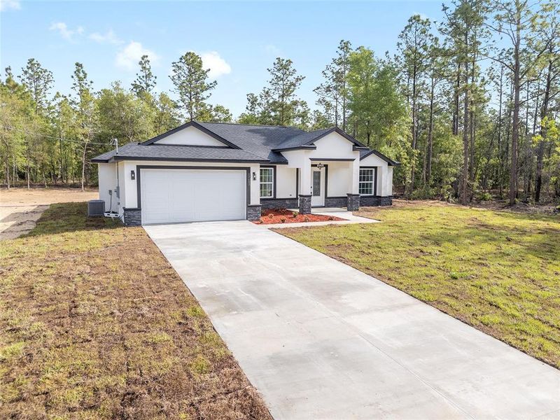 Front exterior of a new home in , Dunnellon, FL, highlighting curb appeal (Image 33).