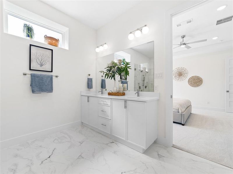 Bathroom featuring double vanity, marble finish floors, a marble finish shower, and ensuite bath