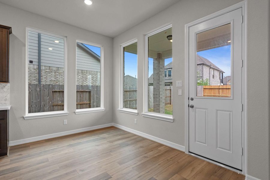 With an abundance of natural light streaming through the windows, the breakfast nook is bathed in a sunny glow, creating the perfect atmosphere to enjoy your morning coffee or a family breakfast.