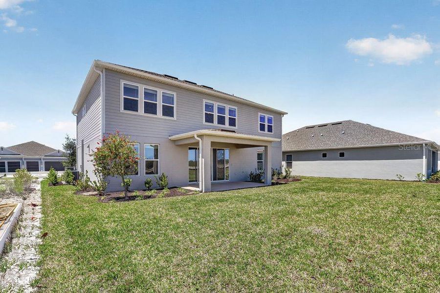 Exterior details and patio area of a home in Ardisia Park, New Smyrna Beach (Image 28).