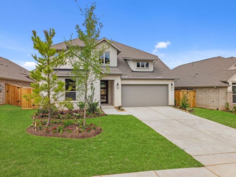 Front exterior of a new home in Wildtree, Magnolia, TX, highlighting curb appeal (Image 21).