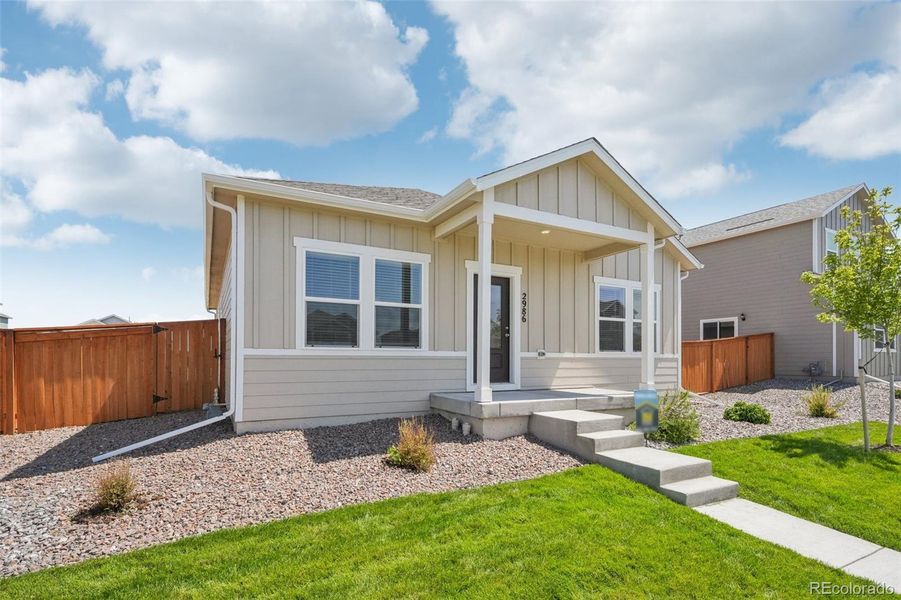Front exterior of a new home in Wolf Creek Run, Strasburg, CO, highlighting curb appeal (Image 1).
