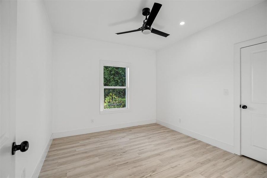 Unfurnished room featuring light wood-type flooring and ceiling fan