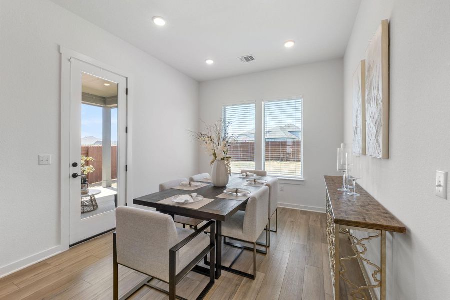 Dining space with light wood-style flooring, recessed lighting, baseboards, and visible vents