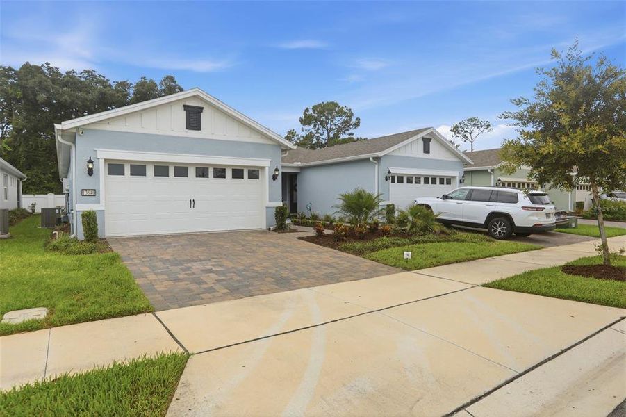 Front exterior of a new home in Del Webb Oasis, Winter Garden, FL, highlighting curb appeal (Image 2). Front exterior of a new home in Del Webb Oasis, Winter Garden, FL, highlighting curb appeal (Image 2).