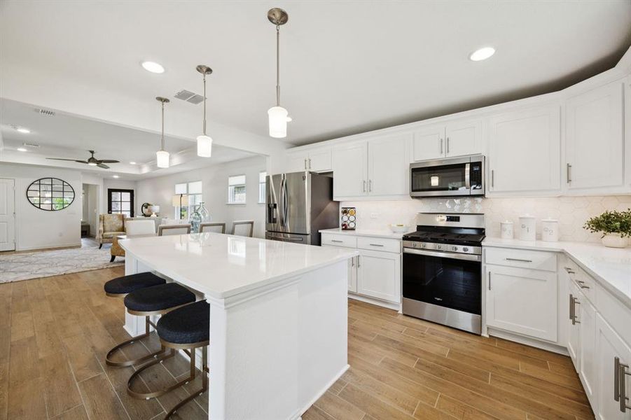 The large island offers space for seating - perfect for catching a quick snack, meal or sitting down if you are doing some laborious meal prep. The kitchen also offers a stainless appliances, including the gas range and microwave.