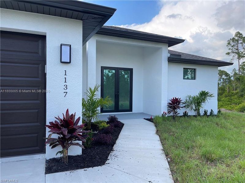 Front exterior of a new home in , Lehigh Acres, FL, highlighting curb appeal (Image 1).