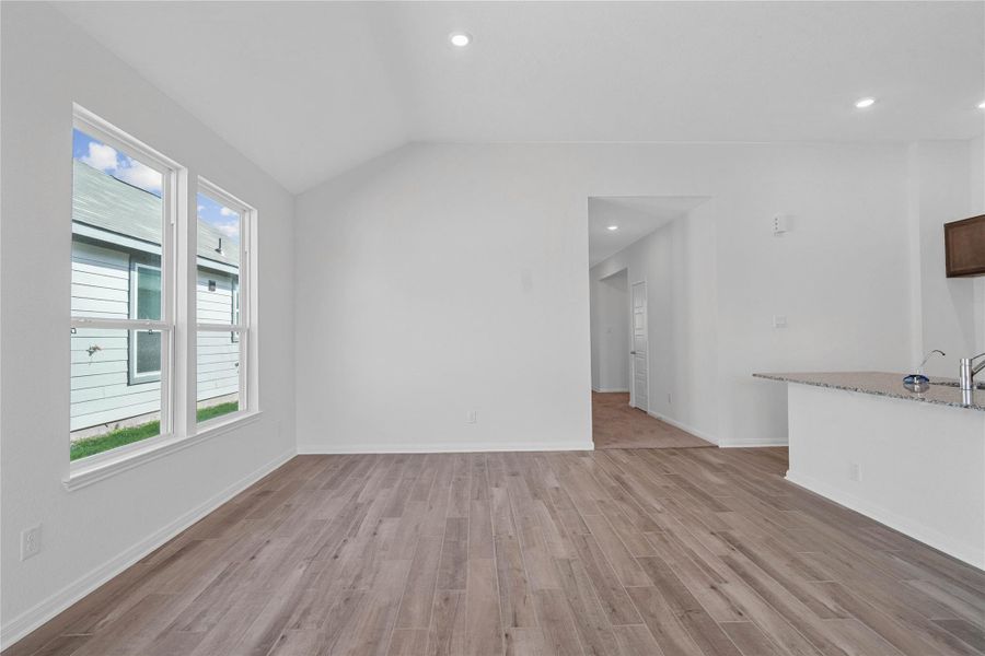 Start your day with a warm cup of coffee and quality time in this charming dining area! Highlights include large windows, custom neutral paint, wood-look tile flooring, recessed lighting and high ceilings.