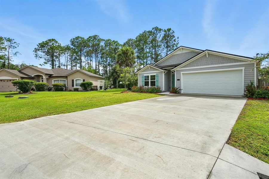Front exterior of a new home in Palm Coast Homesites, Palm Coast, FL, highlighting curb appeal (Image 23).