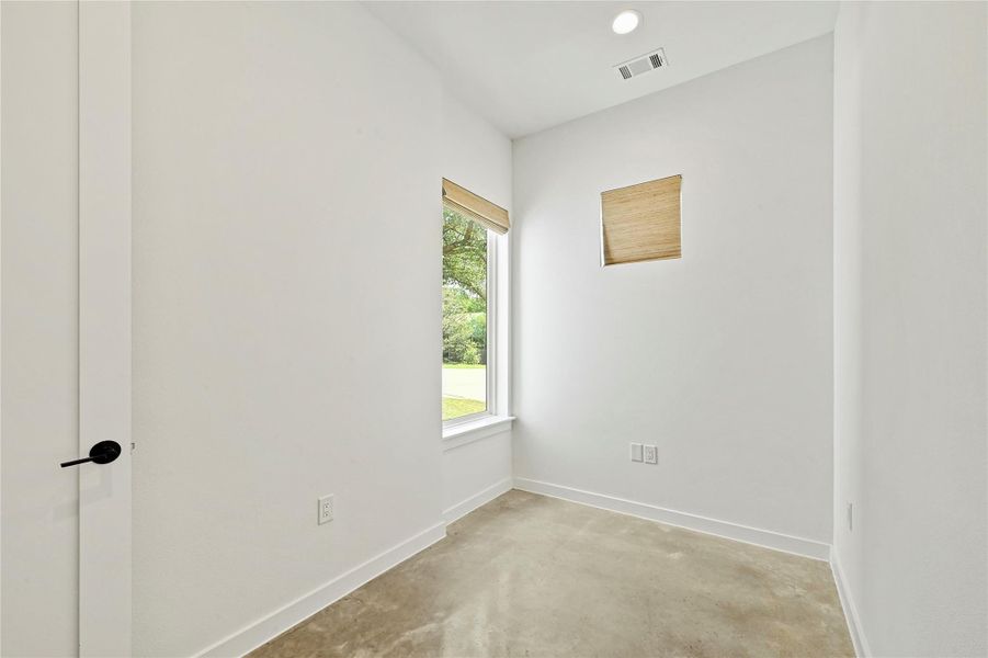 Ground-floor flex room with polished concrete floors — use as a home office, mudroom, or gym. Ground-floor flex room with polished concrete floors — use as a home office, mudroom, or gym.