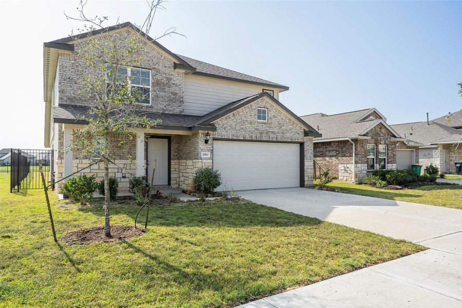 Front exterior of a new home in Sunterra, Katy, TX, highlighting curb appeal (Image 2).