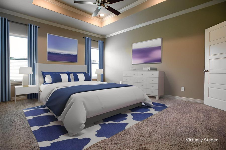Carpeted bedroom featuring baseboards, multiple windows, ornamental molding, and a raised ceiling