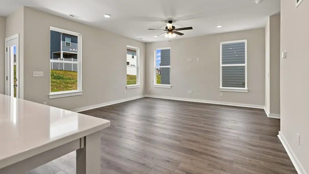 Versatile living space with various windows and backdoor access