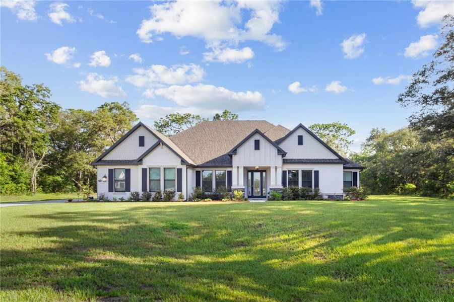 Front exterior of a new home in Bella Terra, Hudson, FL, highlighting curb appeal (Image 23).