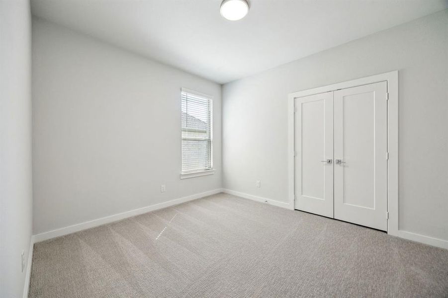 Bedroom in the Wimbledon home plan by Trophy Signature Homes – REPRESENTATIVE PHOTO Bedroom in the Wimbledon home plan by Trophy Signature Homes – REPRESENTATIVE PHOTO