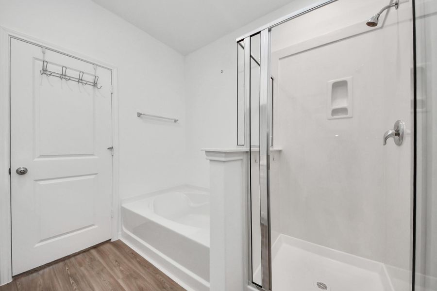 Primary bathroom with separate tub and shower