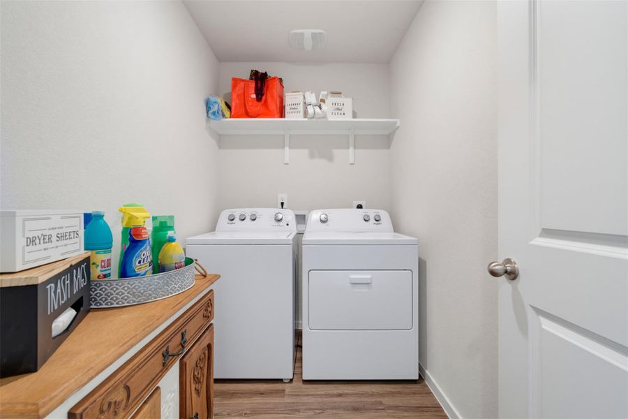 Functional laundry space matches convenient utility with clean design and durable flooring. Functional laundry space matches convenient utility with clean design and durable flooring.