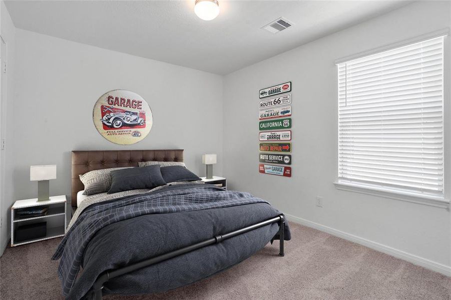 Secondary bedroom features plush carpet, neutral paint, lighting, large window with privacy blinds and ample sized closet space.