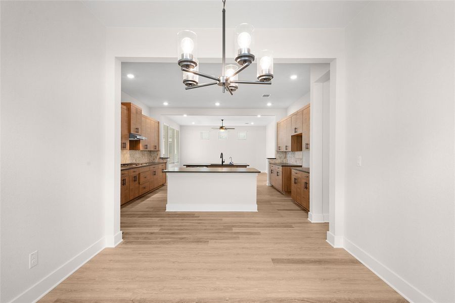 An open-concept design connects a well-appointed kitchen with an elegant dining area, creating an inviting flow. An open-concept design connects a well-appointed kitchen with an elegant dining area, creating an inviting flow.