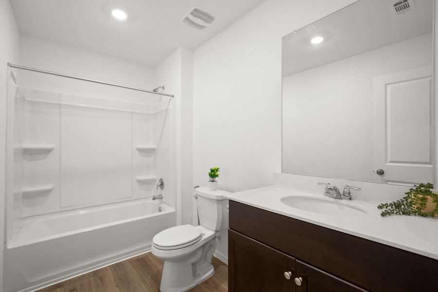The secondary bathroom comes with a lovely single vanity and a shower/tub combo.