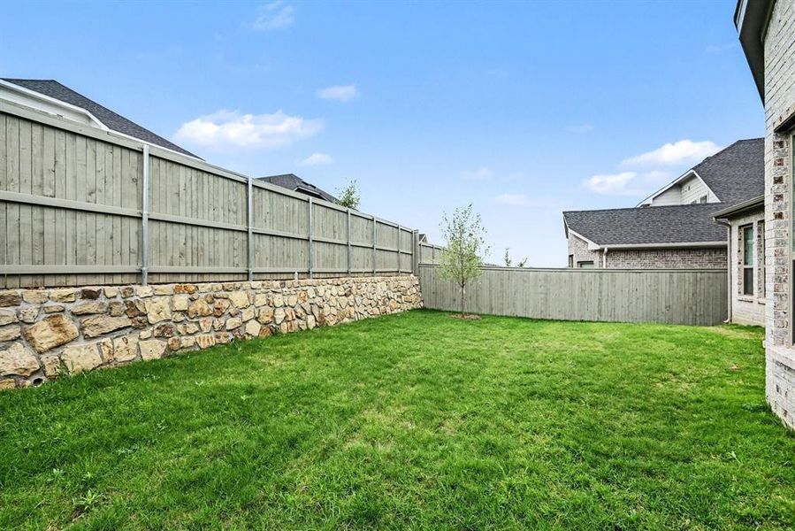 Exterior details and patio area of a home in Pecan Square, Justin (Image 4).