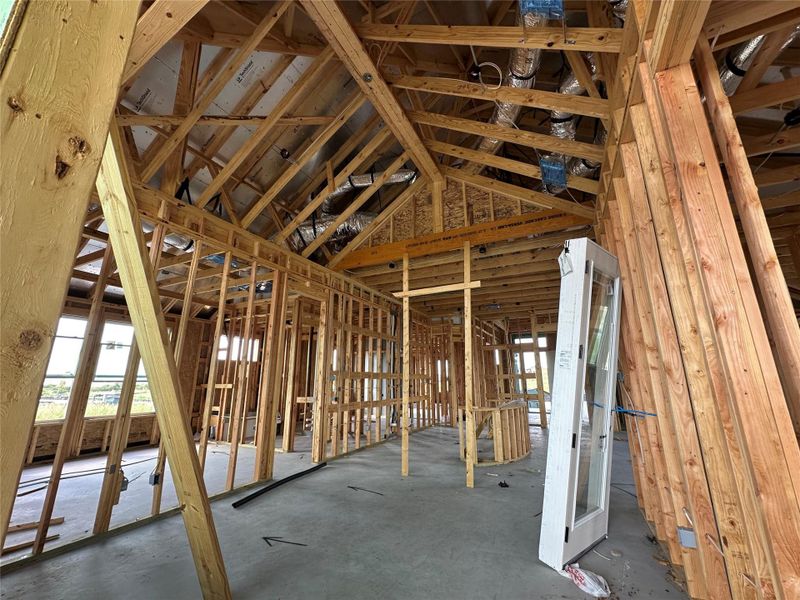 Witness the skeleton of a future home, showcasing sturdy wood framing and the promise of tailored living spaces.