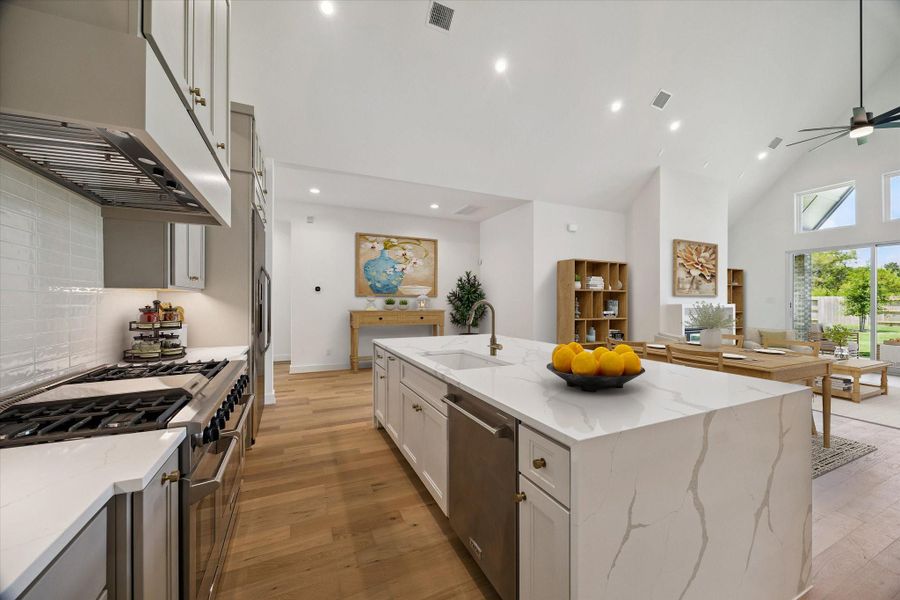 View of the Kitchen, Dining, and Living. This photo has been virtually staged.
